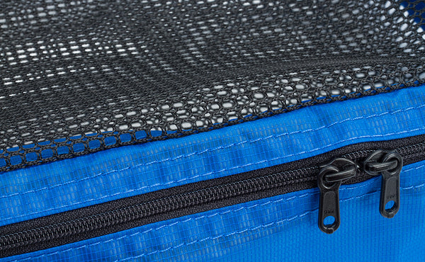 A close shot of the dual zipper pulls and mesh top of a Tri-Star Packing Cube.